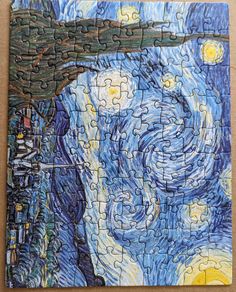 a piece of jigsaw puzzle with the painting starry night