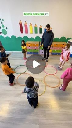 a group of children are playing with hula hoops