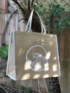 Large jute tote bag with hand painted wave design in white and natural woven handles and edge detailing. Small velcro patch to keep it closed. Perfect beach tote, for grocery shopping, or day trips. Eco-friendly Cream Beach Bag, White Rectangular Jute Beach Bag, White Jute Beach Bag For Everyday Use, White Jute Beach Bag For Daily Use, Eco-friendly White Canvas Beach Bag, Eco-friendly White Jute Beach Bag, Eco-friendly White Jute Bags, Eco-friendly White Tote Beach Bag, White Jute Bags