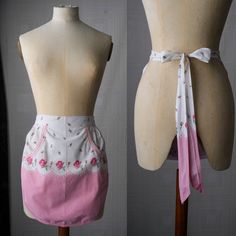 two mannequins wearing aprons with pink flowers on them