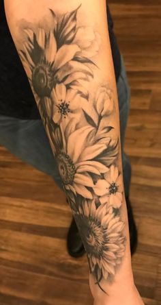 a woman's arm with flowers on it