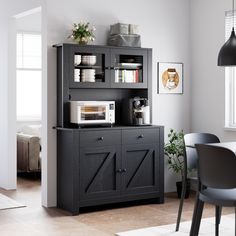 a kitchen area with a microwave, cabinets and table in it's centerpiece