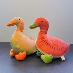 two stuffed ducks sitting next to each other