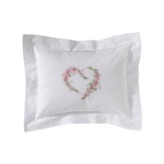 a white pillow with a pink heart embroidered on it's front and back side