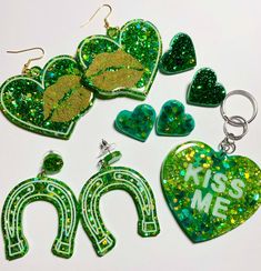 green glitter heart shaped earrings and earring set with the words kiss me on them