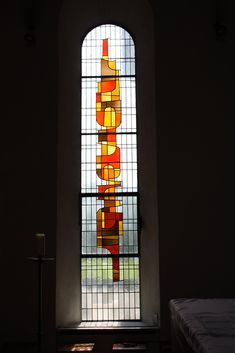 a stained glass window with the word hope written on it in front of a bed