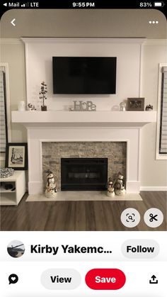 the fireplace is white and has a flat screen tv above it