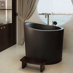 a bath tub sitting next to a window in a bathroom