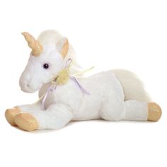 a white stuffed unicorn laying down on its side with a yellow ribbon around its neck