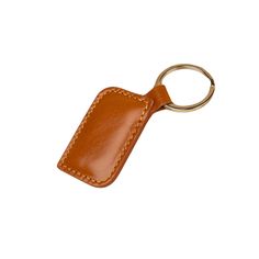 a brown leather keychain with a stitching pattern on the front and back