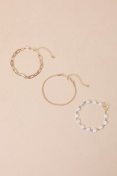 Add a polished look to your 'fit with the Lulus Glamorous Ideal Gold Pearl Chain Three-Piece Bracelet Set! Shiny, gold-toned metal shapes this stunning set of three different bracelets. One has a slender, rope-style chain, while the second boasts a paperclip chain silhouette. The third features round, organically-textured faux pearl accents. Lobster Clasp Closure. Small Bracelet With Faux Pearls Measures 7" Long. Large Bracelet Measures 7" Long With 2. 5" Extender Chain. 40% Iron, 30% Acrylic, 2 Jewel Tone Wedding, Jewel Wedding, Large Bracelet, Small Bracelets, Lulu Fashion, Casual Wedding Dress, Pearl Chain, Jewel Tones, Gold Pearl