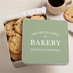 a tin filled with cookies next to a cup of coffee