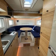 a kitchen and dining area in a small house with wood paneling on the walls