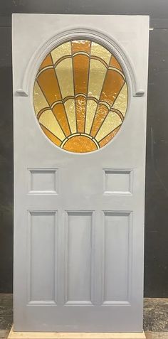 a white door with a stained glass window in the top and bottom panel on it