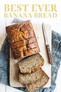 sliced banana bread sitting on top of a cutting board next to a knife and fork