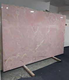 a large pink marble slab sitting on top of a floor