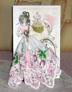 a pink and white card with an image of a woman in a dress on it