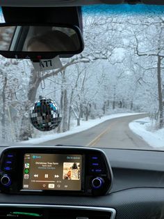 the dashboard of a car with a mirror ball hanging from it's dash board