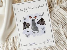 a card with a bat on it sitting next to some knitting needles and other items