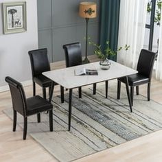 a dining room table with chairs and a rug