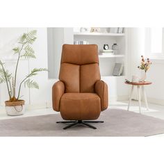 a brown recliner chair sitting on top of a rug