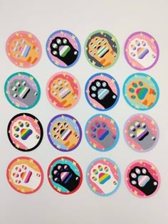 a bunch of different colored stickers with paw prints on them