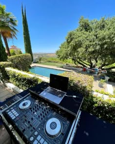 a dj set up in front of a swimming pool