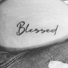 a woman's arm with the word, blessing tattooed on her left side ribcage