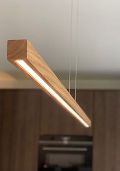 a wooden light fixture hanging from the ceiling