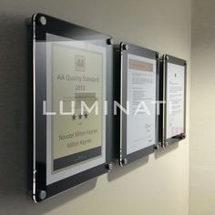 three metal plaques mounted to the side of a wall