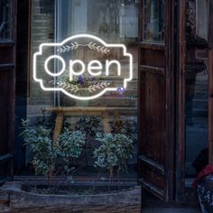 an open sign is lit up in the window