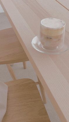 a glass cup sitting on top of a wooden table