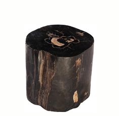 a wooden stool with black and gold paint on it