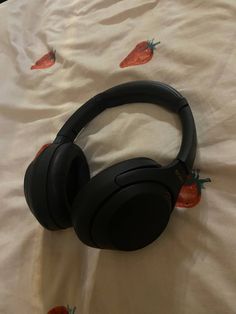 a pair of headphones laying on top of a bed