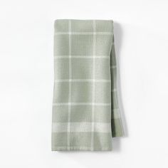 a green and white checkered napkin on a white background