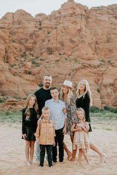 a family poses for a photo in front of the red rocks at valley of fire