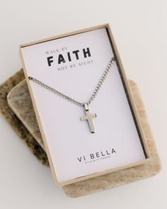 Elevate your style with the Noah Chain. This unisex cross necklace is the perfect accessory, whether you're dressing up or down. The 24" stainless steel chain features a durable stainless steel cross, making it a lasting addition to your jewelry collection. Packaged in a gift box, it's also a thoughtful present for a loved one. Details: 24" stainless steel chain and cross charm Packaged in a kraft paper box with clear lid. Scripture on reverse. Handmade in Haiti by Vi Bella Artisans Mens Christian Gifts, Silver Cross Chain, Adult Baptism Gifts, Steel Cross, Cross Chain, Confirmation Gifts, Walk By Faith, Baptism Gifts, Cross Charms