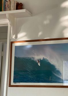 a framed photo of a surfer riding a wave