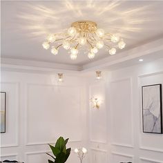 a dining room with white walls and chandelier