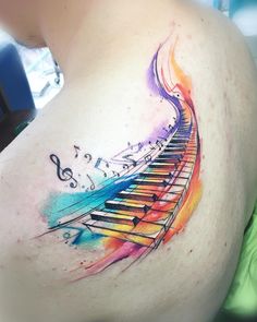 a colorful tattoo with musical notes on it