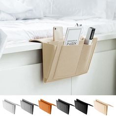 a bed with white sheets and pillows next to an open magazine holder on the wall