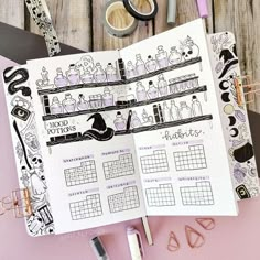 an open planner with black and white illustrations on it