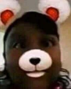 a person with fake ears on their head wearing a teddy bear hat and looking at the camera