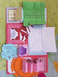 several pieces of paper and crafting materials laid out on a carpeted area with flowers