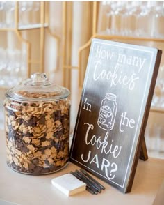 a cookie jar next to a sign that says how many cookies in the cookie jar?