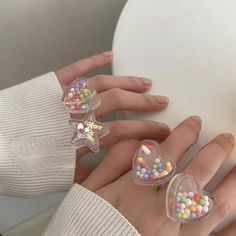 Transparente Ringe aus Bonbonperlen

 Erleben Sie die Eleganz unserer Candy Beads Clear Rings. Diese Ringe sind mit wunderschönen, durchscheinenden Candy Beads verziert, die jedem Outfit einen Hauch von Raffinesse verleihen. Mit ihrem einzigartigen Design und den hochwertigen Materialien werden Sie sie jeden Tag tragen wollen. Werten Sie Ihren Stil mit unseren Candy Beads Clear Rings auf. Clear Rings, Star Rings, Candy Beads, Nerds Candy, Heart Shaped Candy, Cute Love Heart, Color Resin, Y2k Accessories, Candy Jewelry