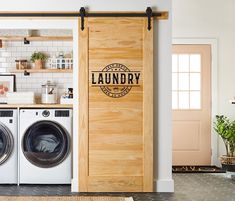 a laundry room with washer and dryer next to a wooden door that says laundry