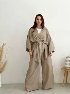 🌿Linen women kimono set with jacket and trousers. You can wear this stylish kimono at home or on the walk, apply kimono, as a cardigan, summer cloak. MORE: https://www.etsy.com/shop/ArtVyshyvankaUA?ref=seller-platform-mcnav%C2%A7ion_id&section_id=38397051 Fabric:  linen ----------------------------------------------------------------------------------------------------- Delivery time after shipping: USA 2-5 weeks Canada 4-6 weeks UK 3-5 weeks EU 2-4 weeks --------------------------------------- Luxury Cream Long Sleeve Kimono, Elegant Linen Kimono With Kimono Sleeves, Beige Linen Kimono, Linen Winter Outfits, Homebody Essentials, Summer Cloak, Kimono Suit, Kimono Modern, Beige Kimono