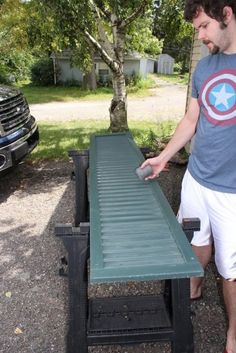 a man standing next to a table with a captain's shield on the top