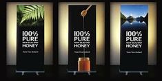 three banners with the words 100 % pure, new zealand and honey on each one